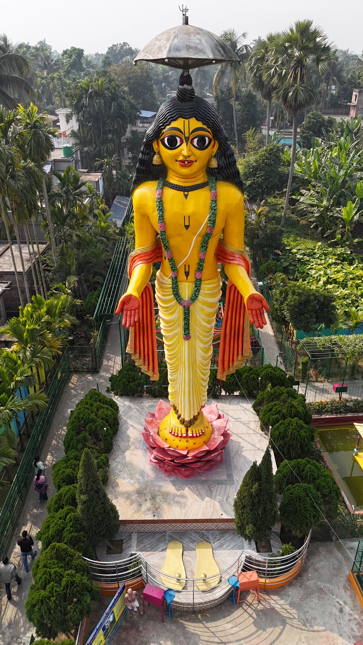 Aerial perspective of the grand golden deity statue at Narahari Dham